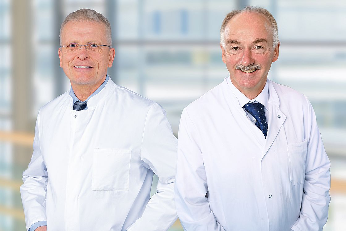 Das Bild zeigt die Portraits von Dr. Jörg Baral und Prof. Dr. Liebwin Goßner (v. l. n. r.)