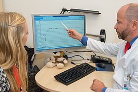 Das Bild zeigt Dr. Matthias Berger im Gespräch mit einer Patientin.