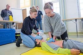 Das Bild zeigt zwei Kursteilnehmende beim Üben der Reanimation.