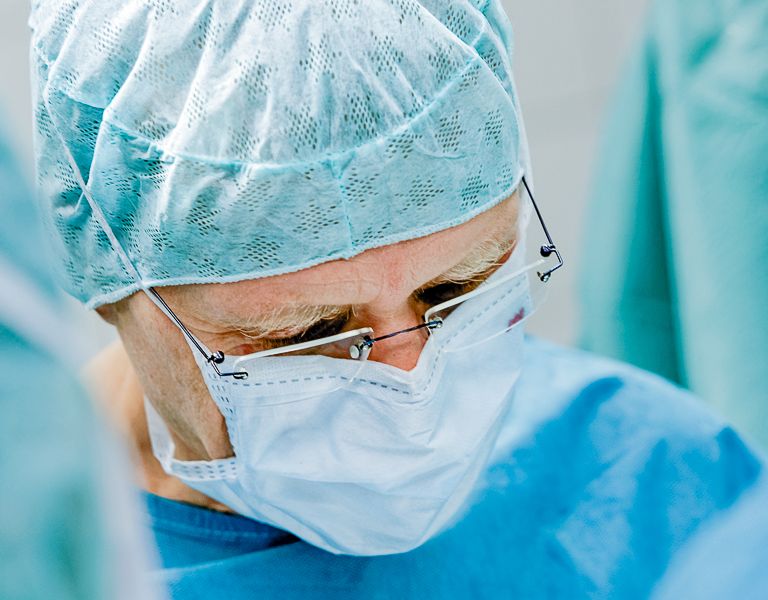 Das Bild zeigt einen Chirurgen bei einer Operation